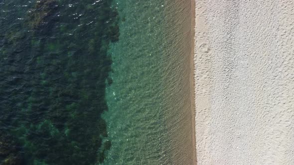 Aerial View on Calm Azure Sea and Volcanic Rocky Shores