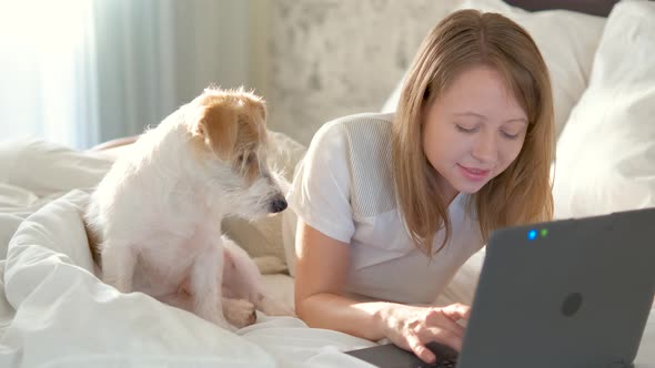 Portrait of a girl in casual clothes with a laptop.