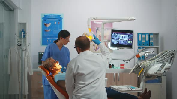 Professional Dentist Working with Gloves During Examination