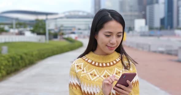 Woman work on mobile phone in city