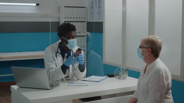 Man Working As Doctor Holding Bottle of Pills