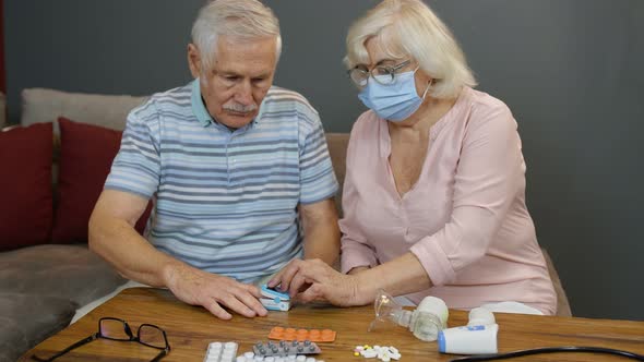 Senior Couple Grandfather and Grandmother Monitoring Oxygen Saturation with Digital Pulse Oximeter