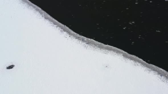 Frozen Waters And Snowy Landscape In Birds Island - aerial shot