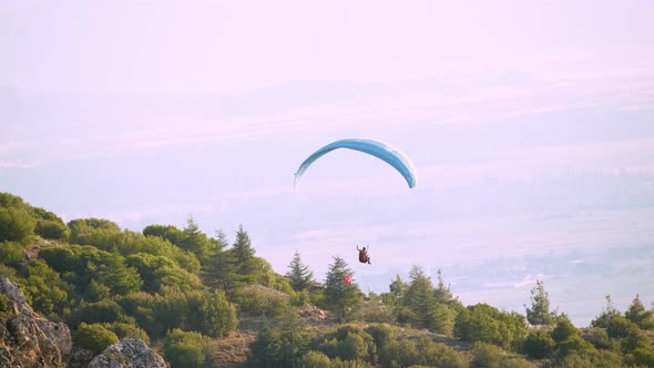 Aerial Shot of a Paraglider Taking off a Hill