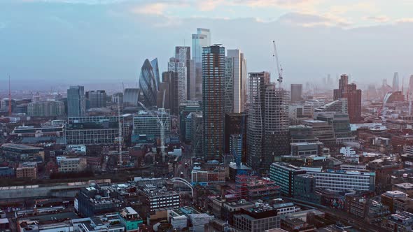 aerial drone shot of skyscrapers in city of London from shoreditch highstreet at sunset