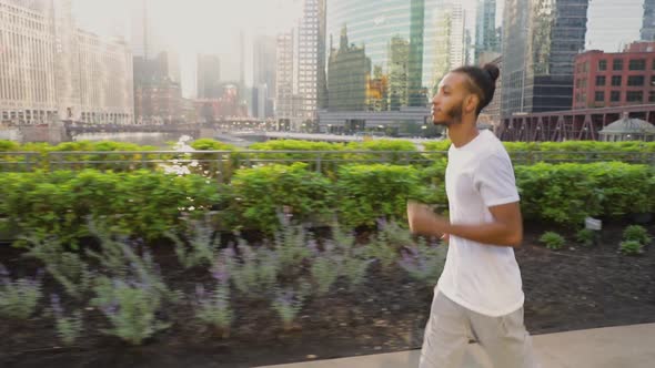 African American man having he morning jog along the Chicago River