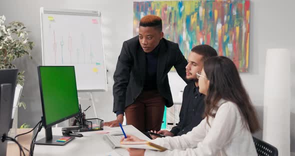 A Man in Suit Conducting Training Asks Questions of Employees Helps Them Develop a Project Strategy