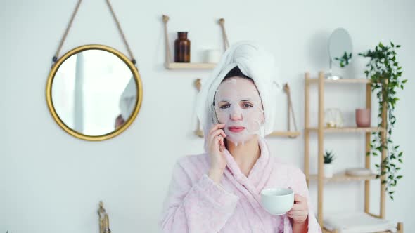 Young Woman with Facial Mask Talking on Phone