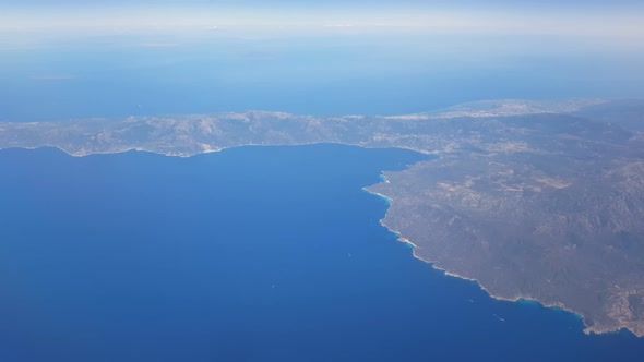 View through an airplane window, traveling by plane