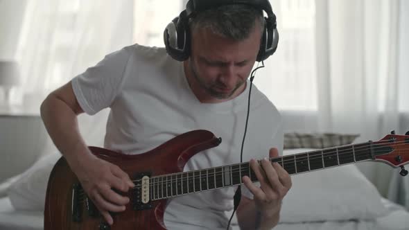 Professional Musician Playing the Guitar at Home