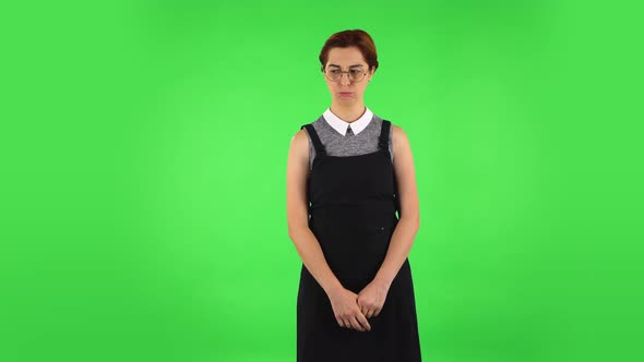 Funny Girl in Round Glasses Is Very Offended and Looking Away. Green Screen