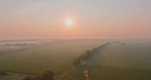 Foggy morning at scenic meadow with beautiful autumn misty sunrise landscape the dense fog