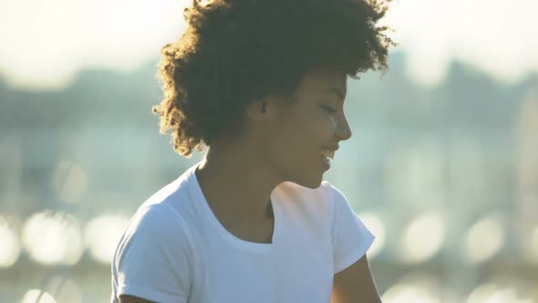 Beautiful Curly Haired Woman Eating Fresh Apple Outdoors, Healthy Eating, Diet