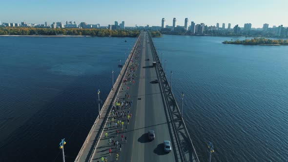 Aerial Drone Fooage. Marathon Running On The Bridge.