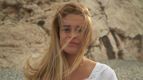 Portrait of Young Beautiful Woman with Amazing Blond Hair in the Wind