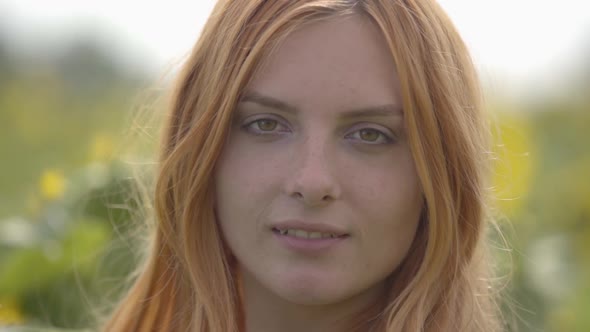 Close-up Portrait of Charming Confident Sensual Girl with Red Hair and Green Eyes Standing on