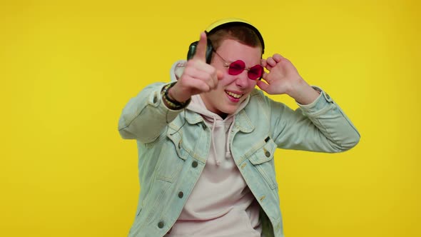 Cheerful Attractive Man Listening Music Via Headphones and Dancing Disco Fooling Around Having Fun