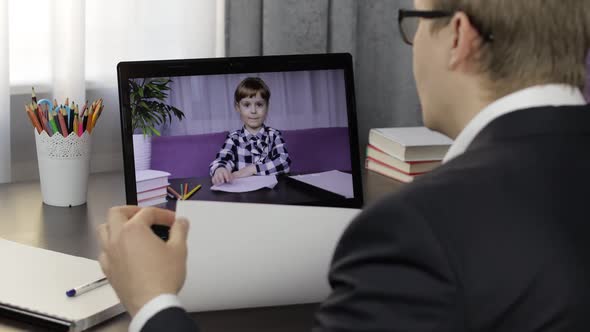 Man Teacher Making Video Call on Laptop with Little Pupil. Distance Education