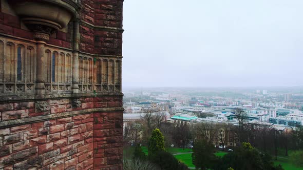 Old church on hill overlooking city of Bristol, England. Drone ascending with panoramic view of city
