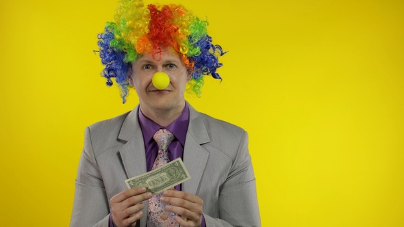 Clown Businessman Entrepreneur in Wig Holds One Buck Money Income and Loses It