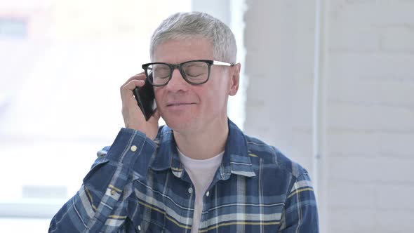 Portrait of Casual Middle Aged Man Talking on Smartphone