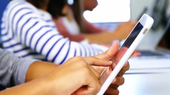 Student using digital tablet in classroom