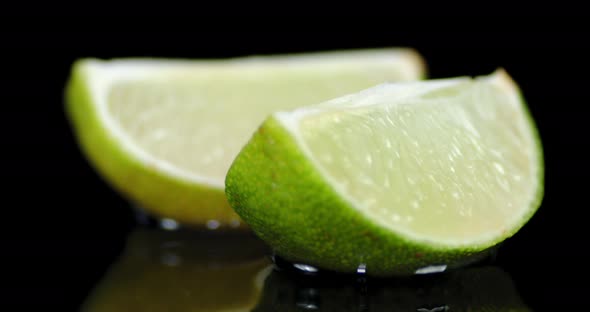 Pieces of Ripe Lime Slowly Rotating. 