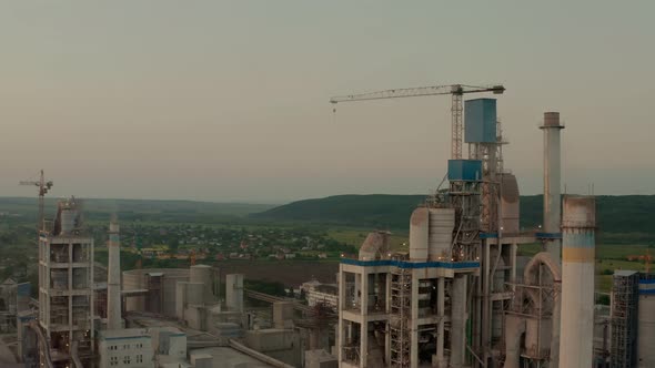 Cement Plant with High Factory Structure at Industrial Production Area at Sunset