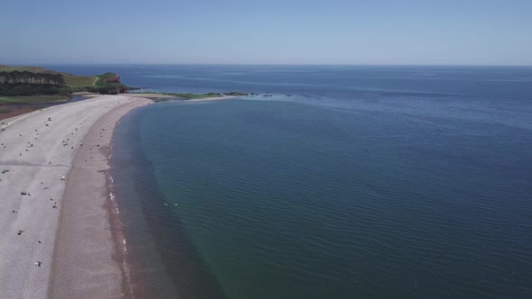 An aerial flyover of the beautiful pebble beaches of Budleigh Salterton, a small town on the Jurassi