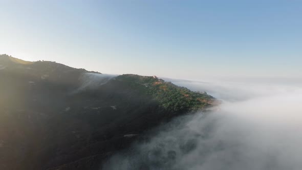 Aerial shoot of canyon in the clouds and morning sun in Malibu Canyon, Monte Nido, California, USA