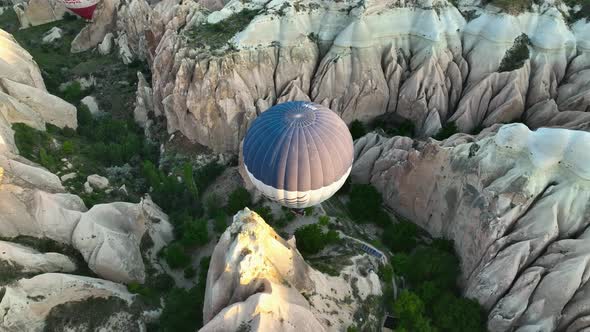 4K Aerial view of Goreme. Colorful hot air balloons fly over the valleys.