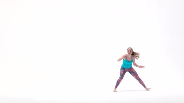 Energetic Girls Are Practicing Capoeira in White Background of Studio. Afro-Brazilian Martial Art