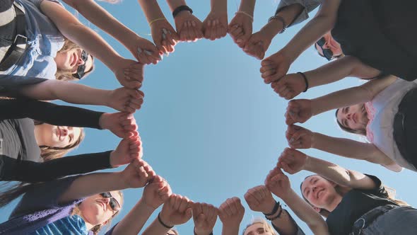 A Group of Girls Makes a Circle From Their Fists of Their Hands