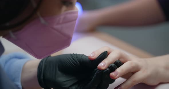 Manicurist Applies Gel Lacquer to the Nails of the Client at Beaty Salon Cosmetology and Beauty