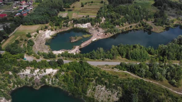 Aerial View of Road Running Through Lakes Surrounded by Nature