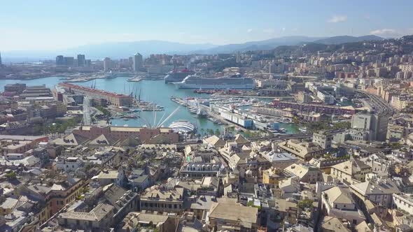 Aerial panoramic drone view of buildings and streets surrounding Port of Genoa.Cruise ships