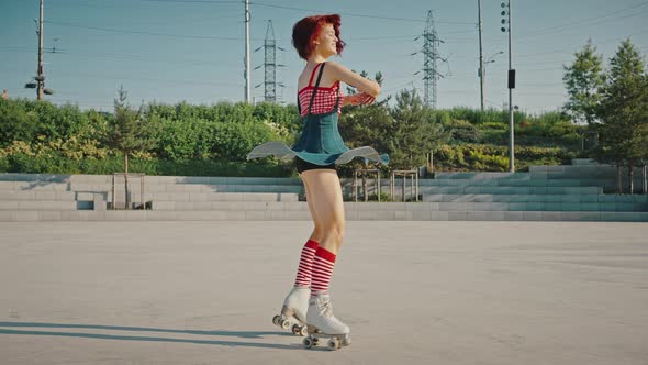 Young Beautiful Lady in Classic Roller Skates Figure Rollerblading Alone in Urban Park Dancing