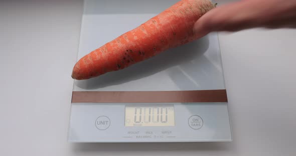 Weighing Carrot on a Kitchen Scale