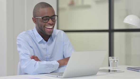 African Man Talking on Video Chat on Laptop