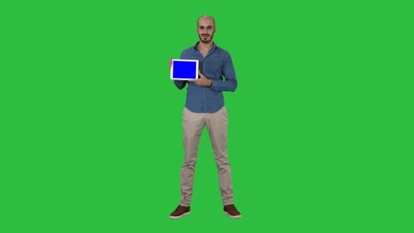 Smiling casual man presenting a tablet with a blank screen