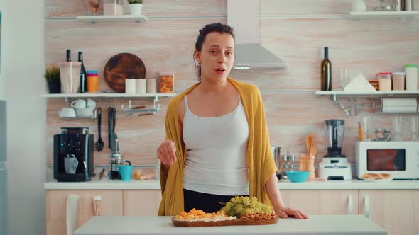 Woman Vloger Siting at Home Kitchen