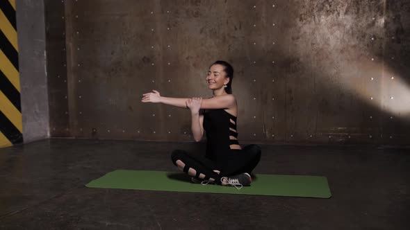 Stretching in the Gym on a Yoga Mat