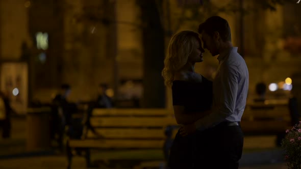 Romantic Couple Hugging and Enjoying Date in City Park in The Evening, Love