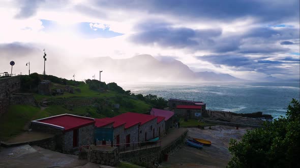 Timelapse of cloudsing over mountain, viewed from historic old harbour in Hermanus, South Africa.