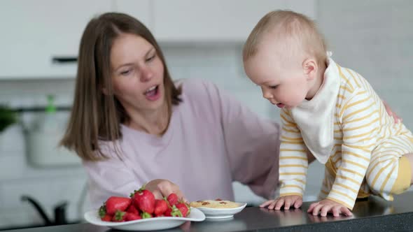 Mother and Baby Cooking on Kitchen at Home