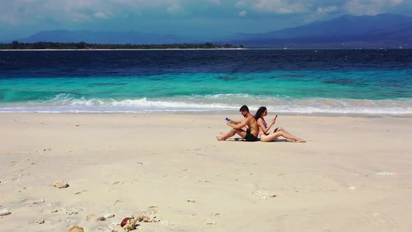 Fun man and woman in love dating on vacation spend quality time on beach on clean white sand backgro