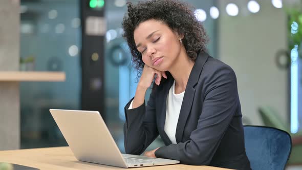 African Businesswoman Sleeping in Office at Desk