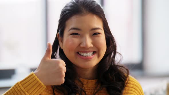 Portrait of Happy Asian Woman Showing Thumbs Up