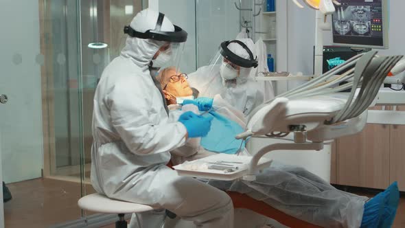 Dentist with Medical Overall Checking Patient Dental Problem