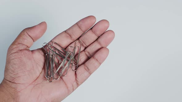 Hand Holding Paper Clips 